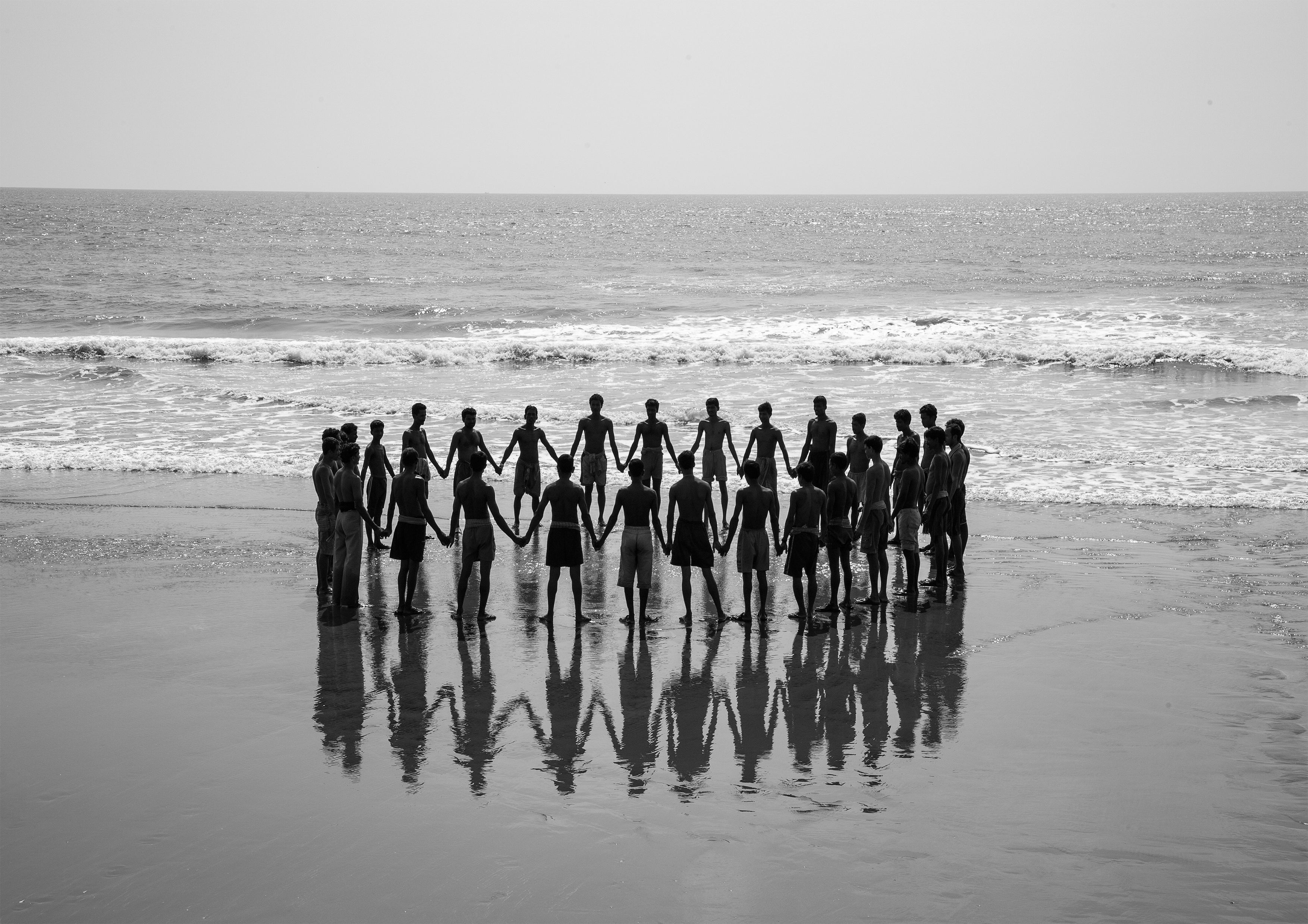 Fishermen in a circle holding hands